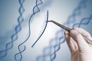 A hand holding tweezers. They are holding an illustration of some genetic code which has been snipped away from the helix