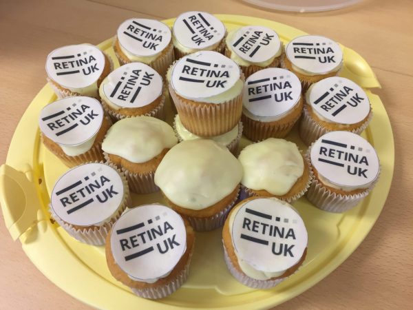 A plate of cupcakes with Retina UK cake toppers on the top of them