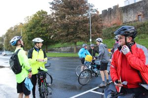 A few cyclists at the first cheer point, all smiling