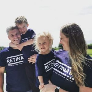 Image shows two adults and two young children wearing blue Retina UK t-shirts
