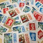 Lots of used stamps spread across a table