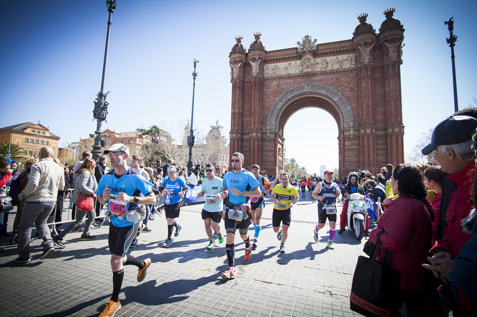 Runners in the Barcelona half marathon - there is a large arch in the background