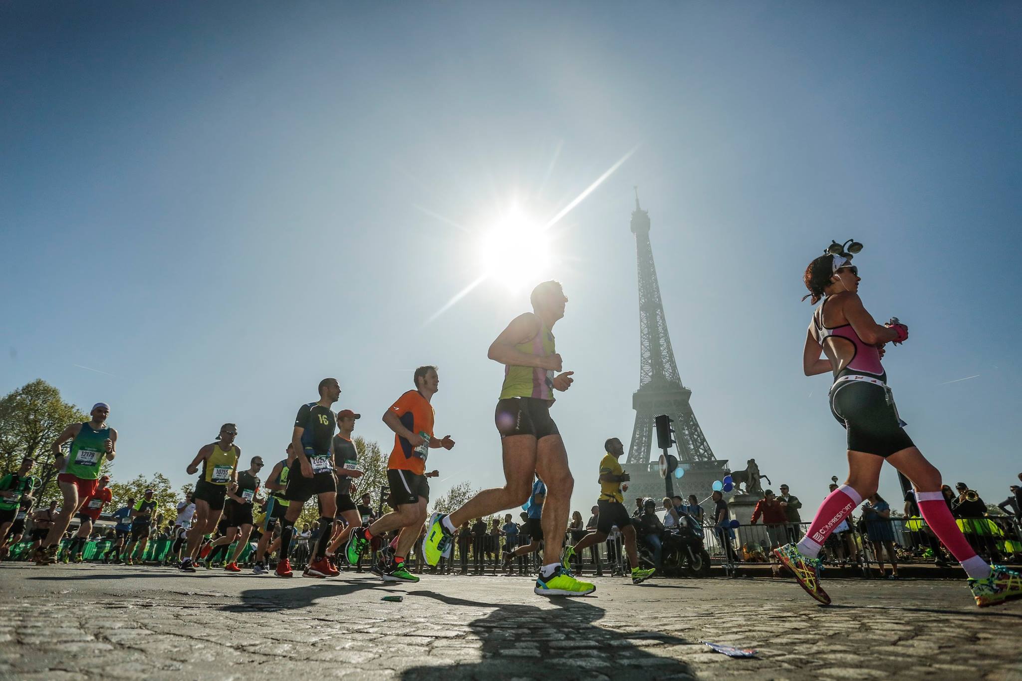 Runners at the Paris Marathon. The Eiffel Tower can be seen in the background