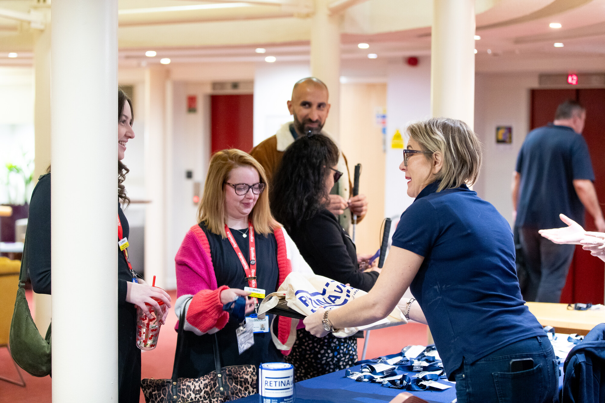 Retina UK Chief Executive, Tina Garvey, handing over a goodie bag to our Professionals' Conference delegates