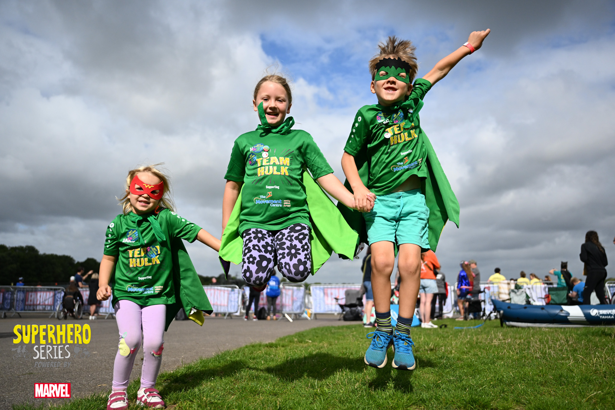 A group of kids, wearing green, take part in the Superhero Tri.