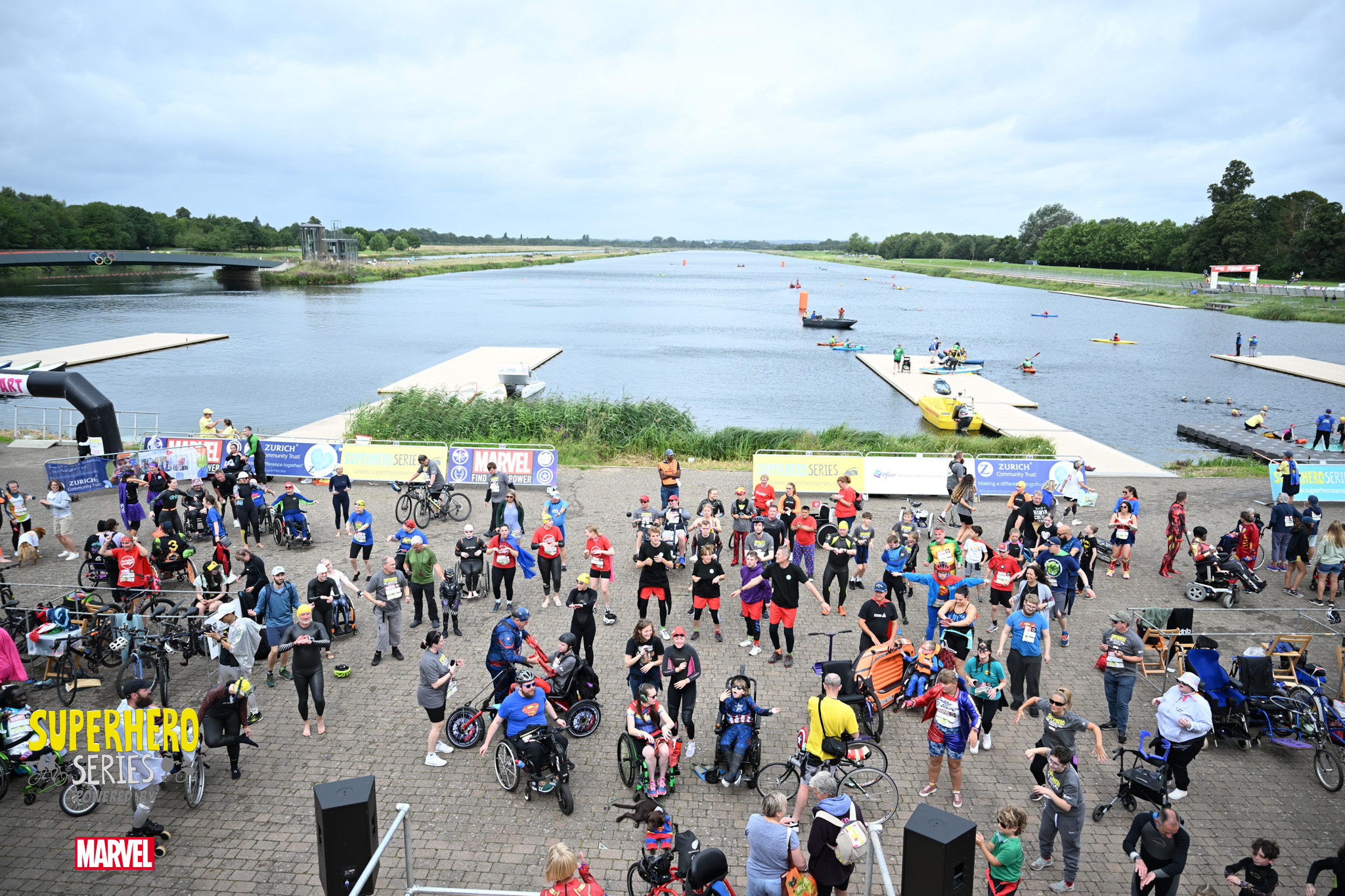 A group of people gather around Dorney Lake waiting for the event to start.