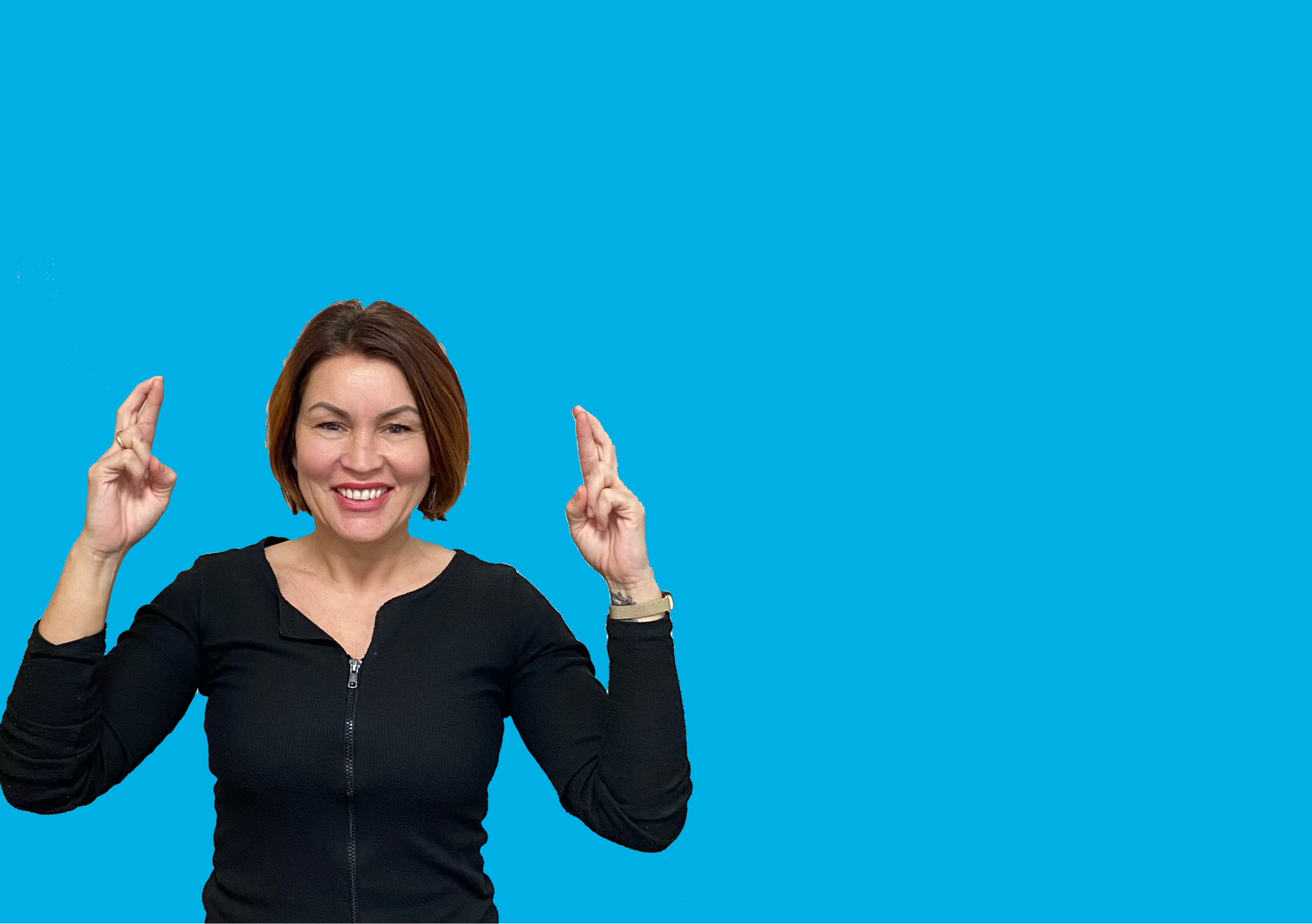 A woman with her fingers crossed on a light blue background