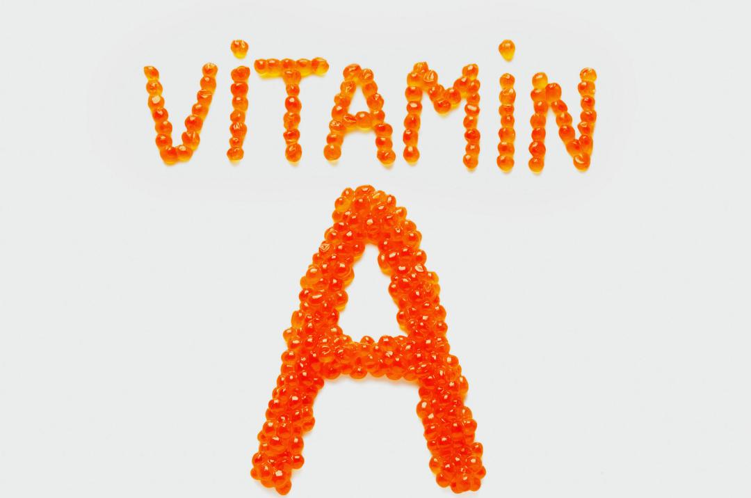 Vitamin A spelled out in orange round capsules