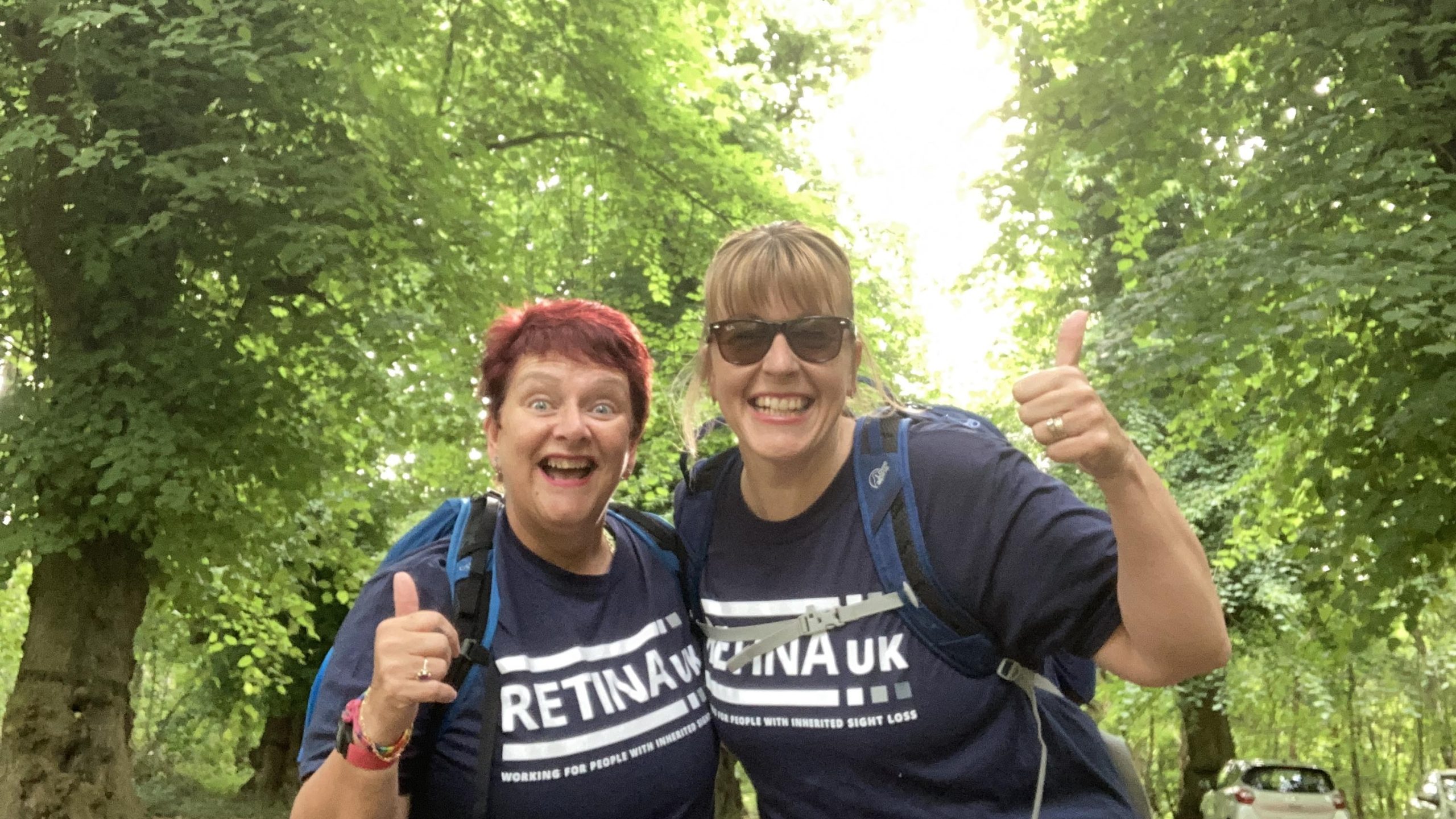2 ladies hiking, wearing Retina UK t-shirts.