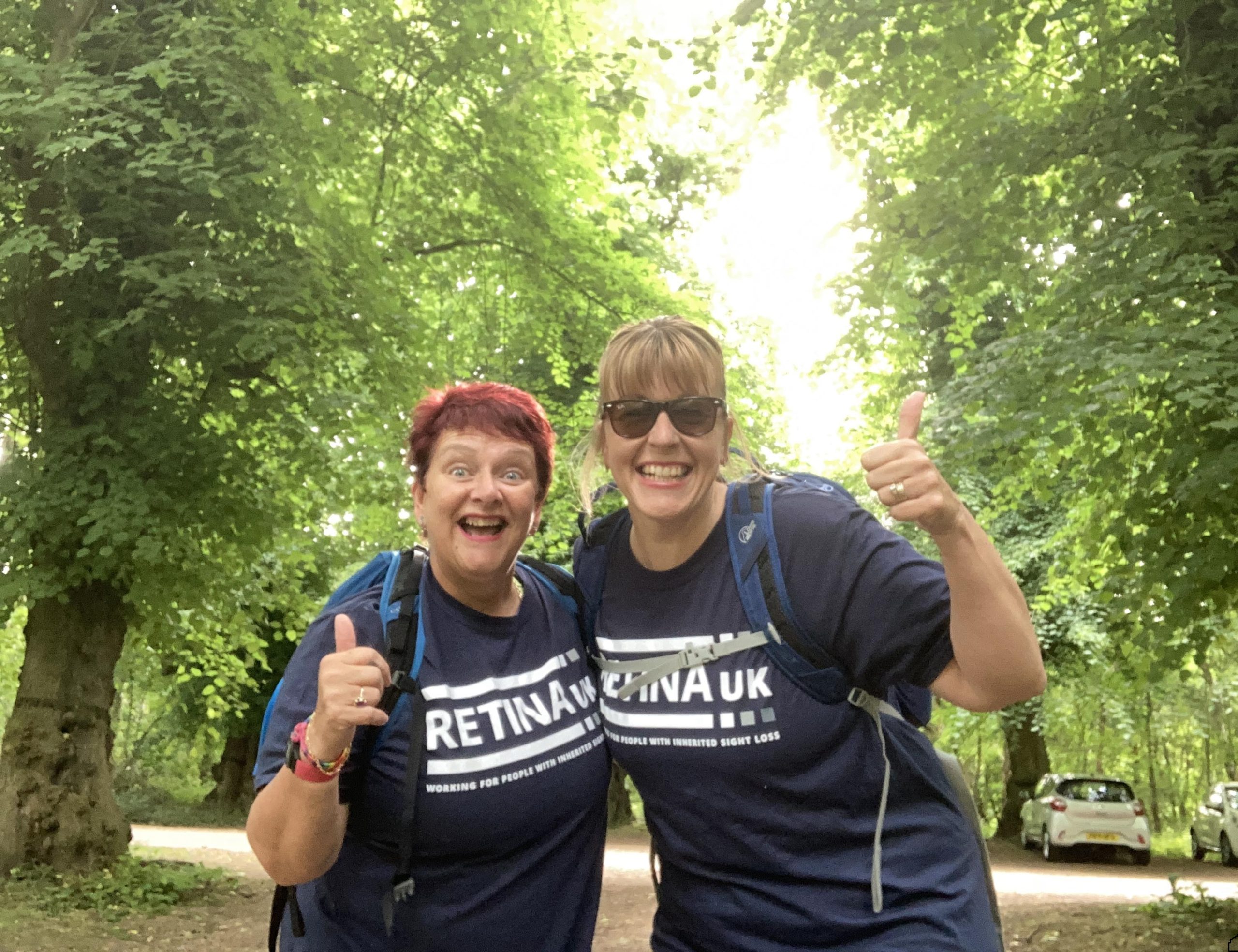 2 ladies hiking, wearing Retina UK t-shirts.