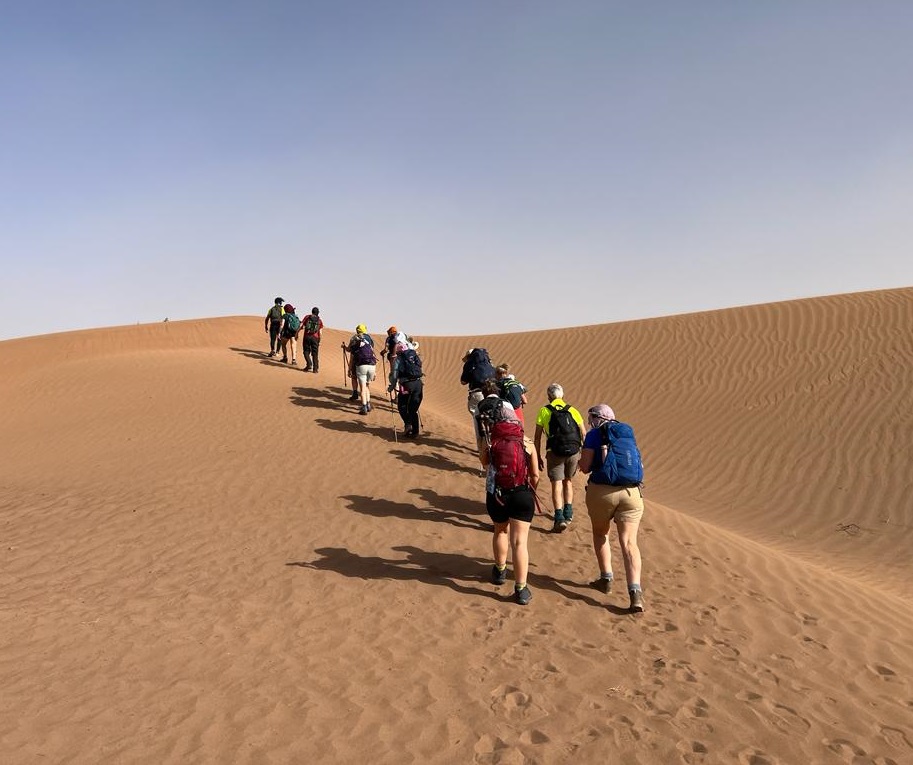 Hikers trekking across the Sahara