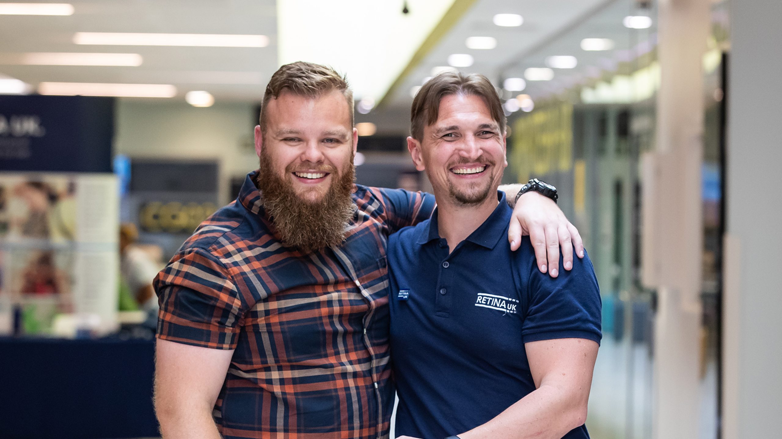 Two men facing the camera. They are both smiling