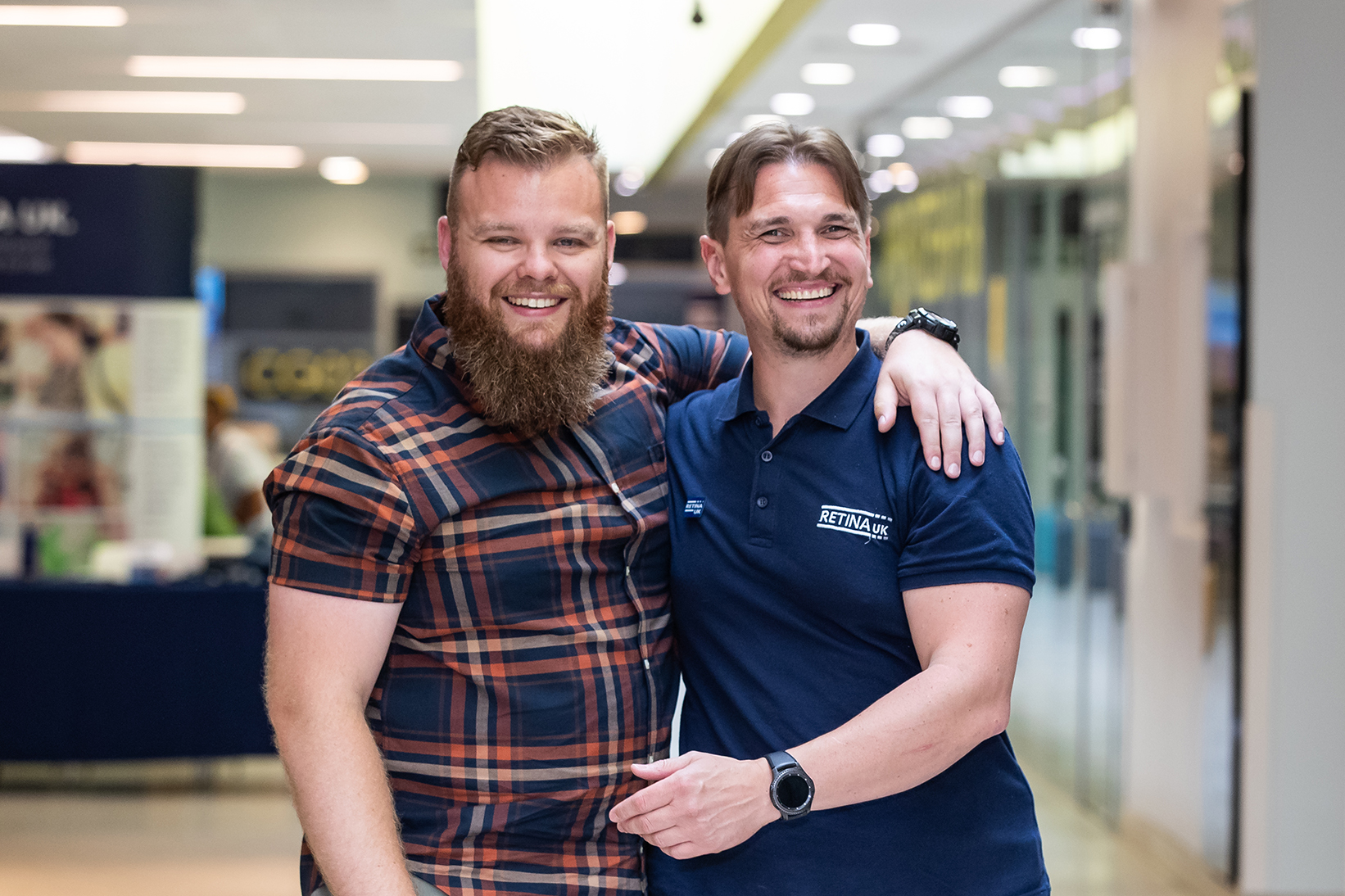 Two men facing the camera. They are both smiling