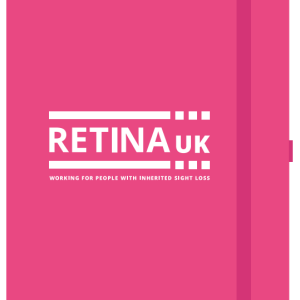 A pink notebook with the Retina UK logo on the front.