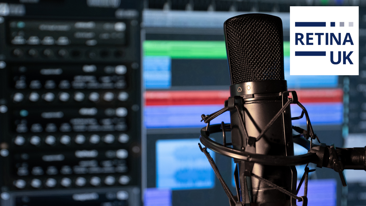 A large microphone in front of a panel of buttons and a screen showing coloured strips