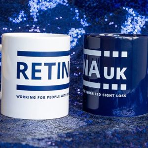 One navy blue and one white mug with the Retina UK logo on both