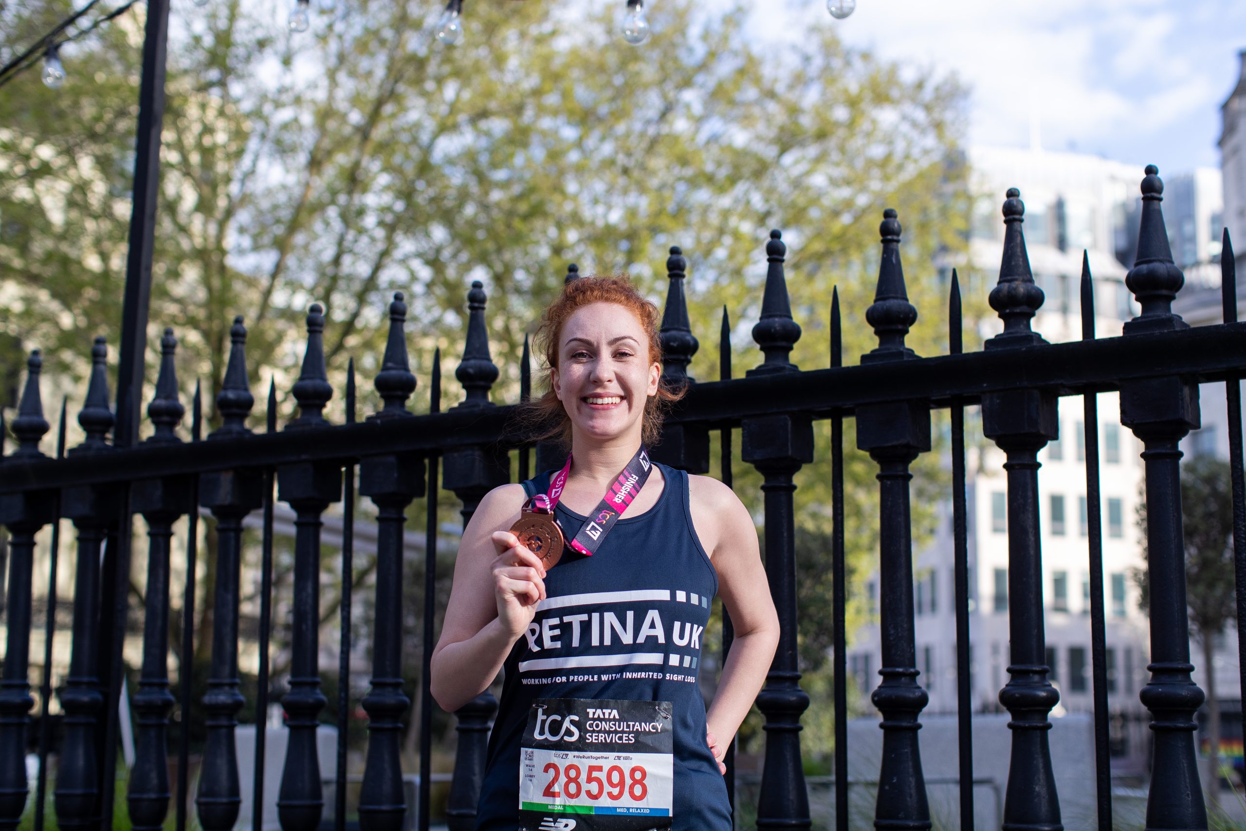 A smiling female runner at the London Marathon.