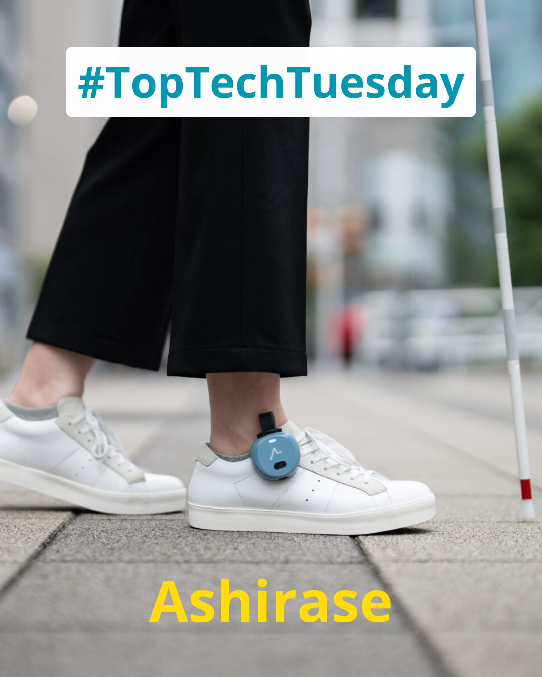 Forefront of the image are two legs, wearing black trousers and white trainers and holding a white cane. On the right foot, there is a blue circular device attached to the shoe. Above the image is the blue text 