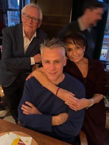 An image of Paul Bacon with his partner and son in a restaurant.