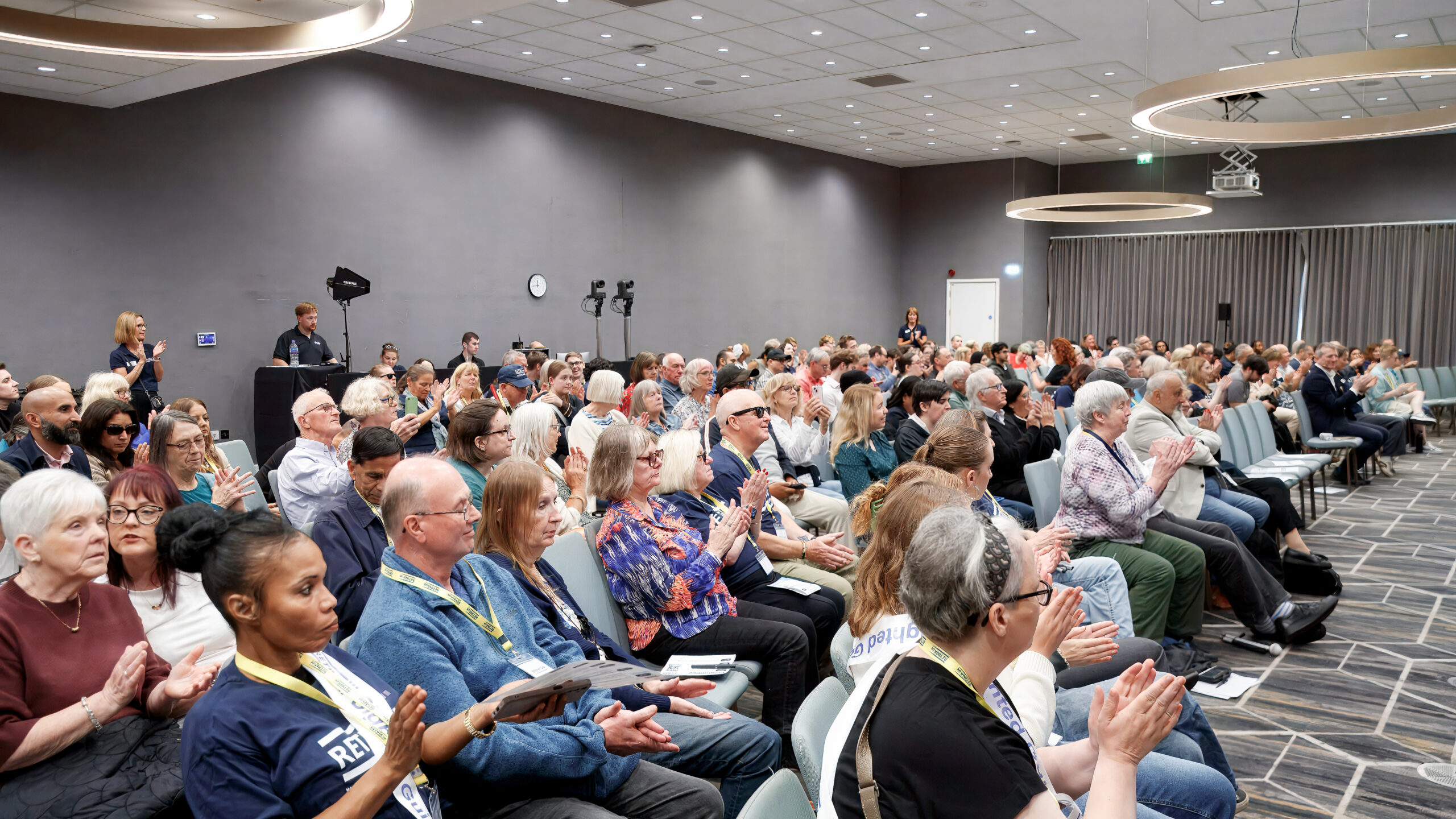 Picture from the annual conference shows a room full of delegates sat watching a presentation.